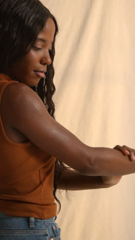 Studio-Beauty-Shot-Of-Young-Woman-Putting-Moisturiser-Onto-Skin-On-Shoulder-3